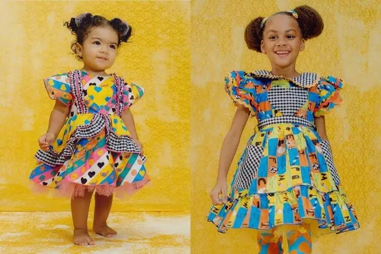 Meninas usando vestido junino colorido com xadrez branco e preto