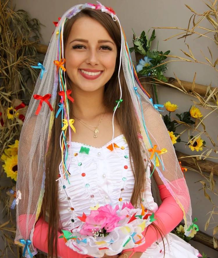 Noiva caipira com vestido branco e véu com laços