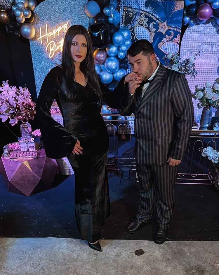 casal com fantasia de família addams