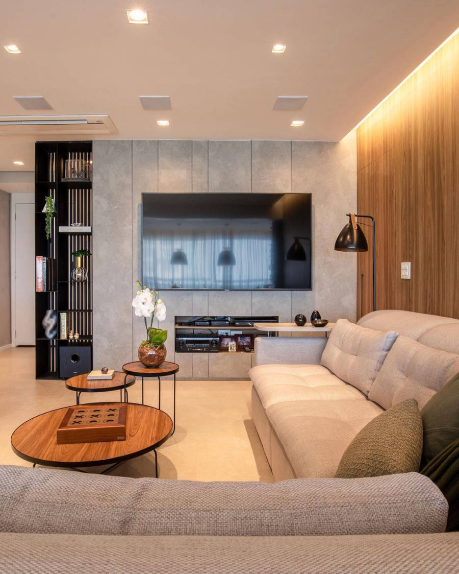 Sala de tv com sofá em L e nicho para eletrônicos.