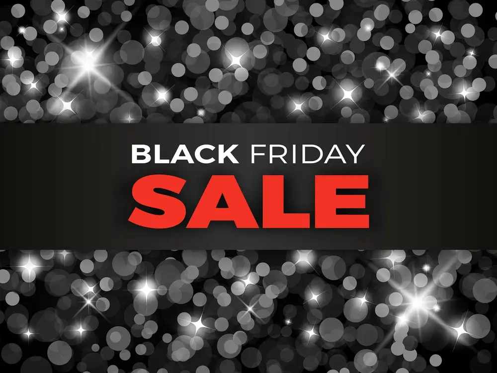 Escrito "Black Friday Sale" de branco e vermelho em faixa preta com fundo preto brilhante
