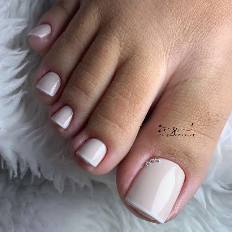 Unhas dos pés decoradas francesinha nude com 3 pedrinhas