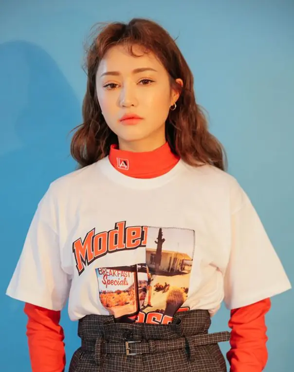 Modelo usa t-shirt, blusa de manga comprida e short xadrez Modelo usa t-shirt, blusa de manga comprida e short xadrez