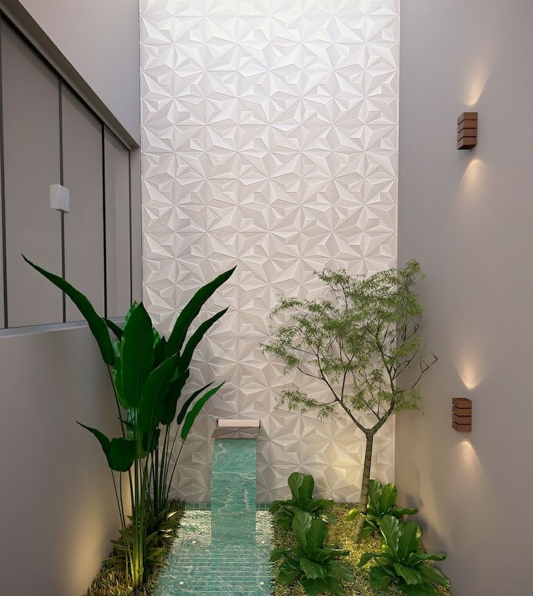 Jardim de inverno com parede 3d branca, cachoeira e plantas