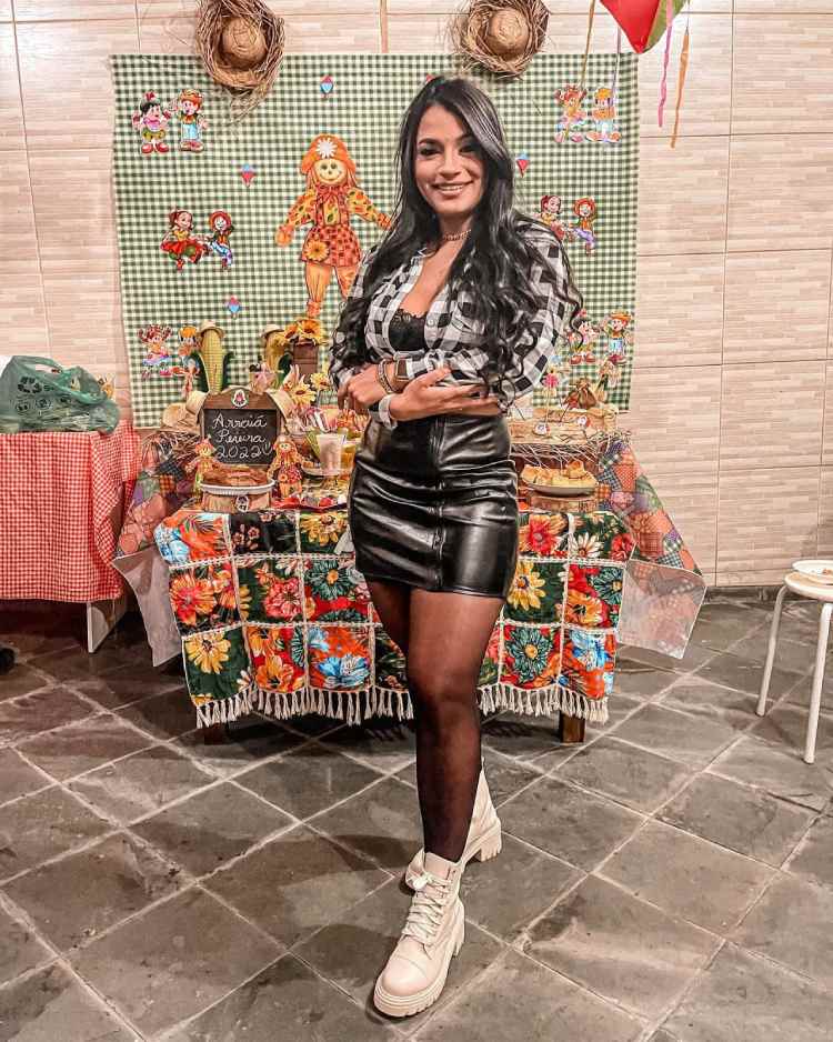 mulher cm saia e top preto, por cima camisa xadrez