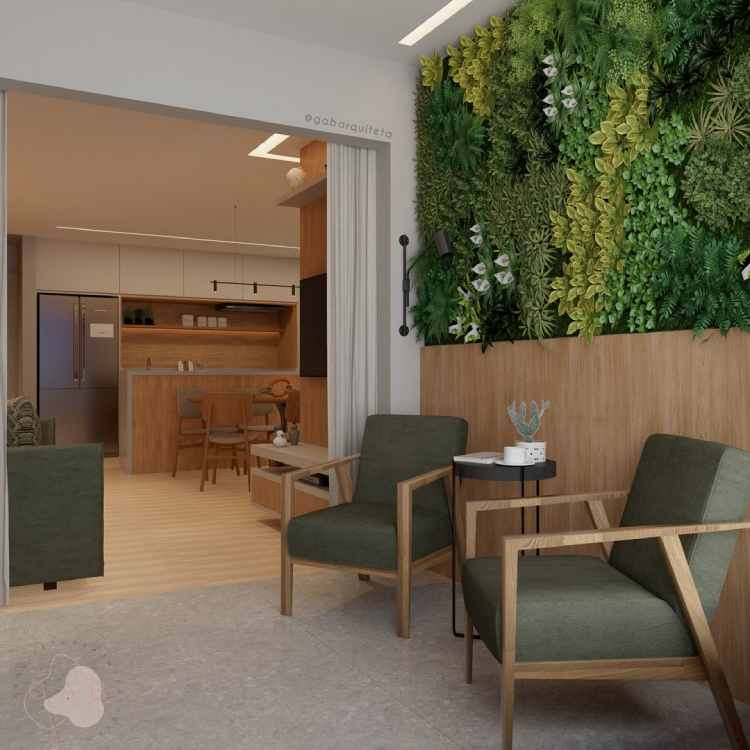varanda com uma parede em jardim vertical e duas poltronas verdes