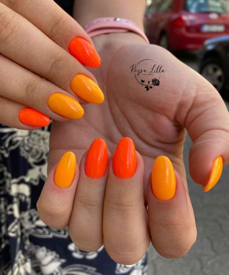 Unhas decoradas simples cores quentes, laranja e amarelo.