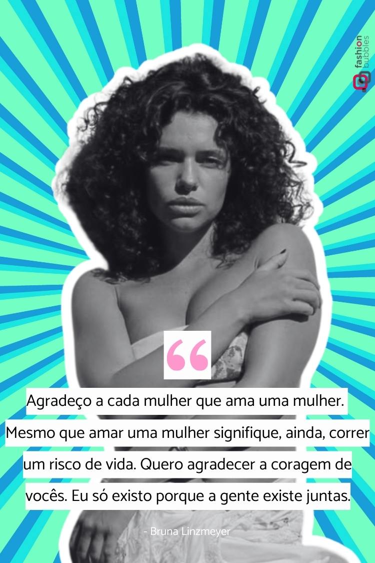 Uma mulher de pele clara e cabelo escuro e encaracolado está com os braços cruzados, olhando para a frente. A imagem apresenta uma citação atribuída a Bruna Linzmeyer, expressando gratidão e reconhecimento à coragem de mulheres que amam outras mulheres. Imagem ilustra matéria sobre LGBT frases dos famosos.