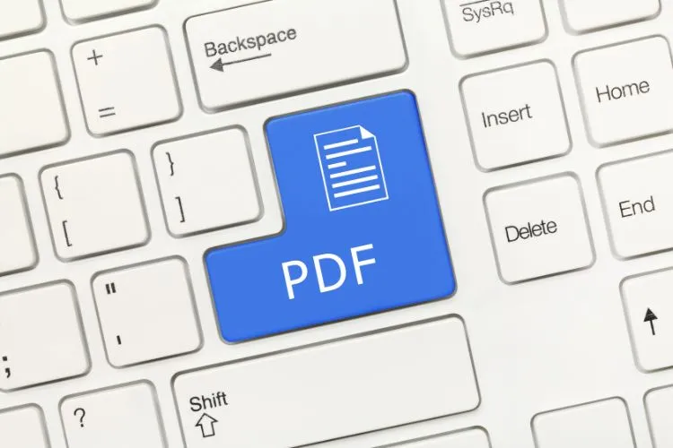 Um teclado de computador com uma tecla grande e azul destacada, marcada com "PDF" e um ícone de documento. Esta imagem simboliza a capacidade do Google NotebookLM de importar e organizar diferentes tipos de arquivos, incluindo PDFs, para facilitar a gestão de notas.