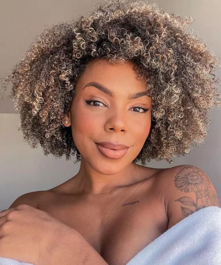 Corte em camadas mulher com cabelo castanho e loiro crespo
