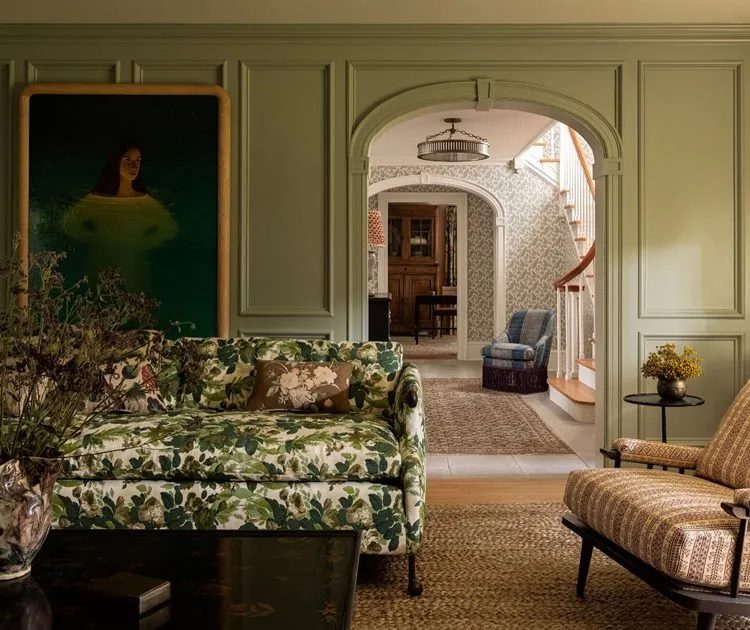 sala de estar com estampa chintz no sofá, tapetes e também em papel de parede