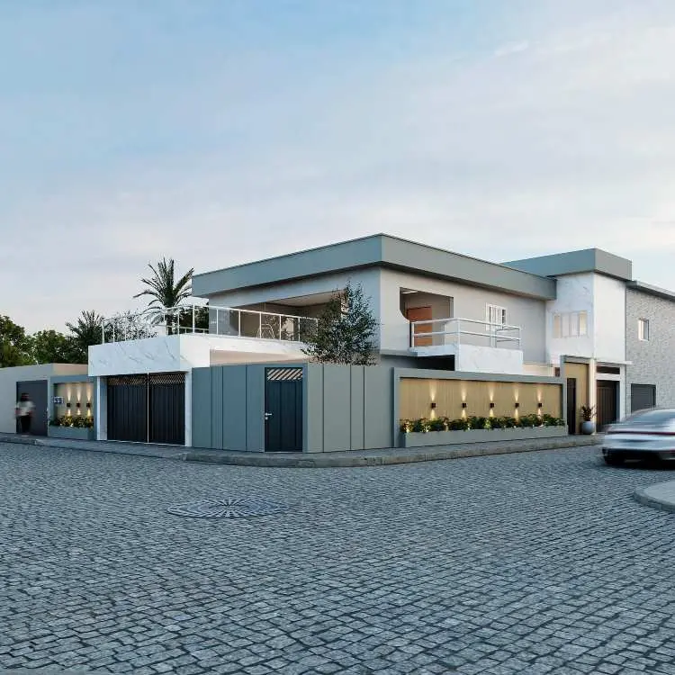 Casa moderna em esquina com telhado plano e dois pavimentos. Fachada com tons cinza e branco, cercada por muro contemporâneo com portão metálico. Detalhes de paisagismo e iluminação embutida destacam sua sofisticação. Varanda ampla com guarda-corpo de vidro.