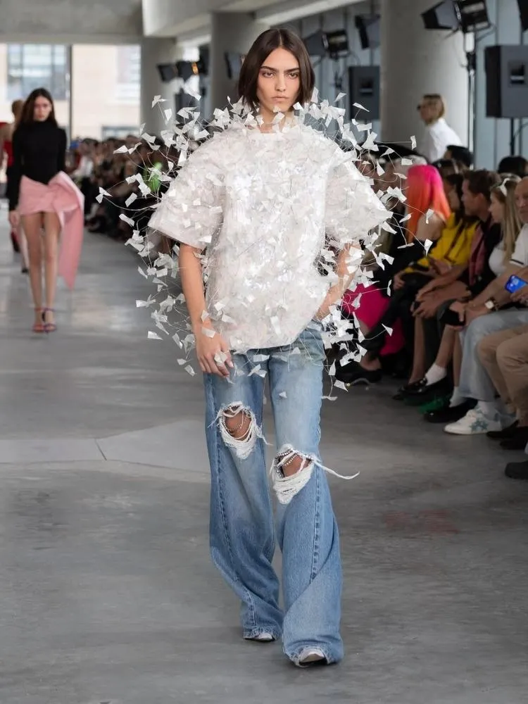 Foto de modelo usando calça jeans destroyed da AREA, uma das tendências da Semana de Moda de Nova York 2025