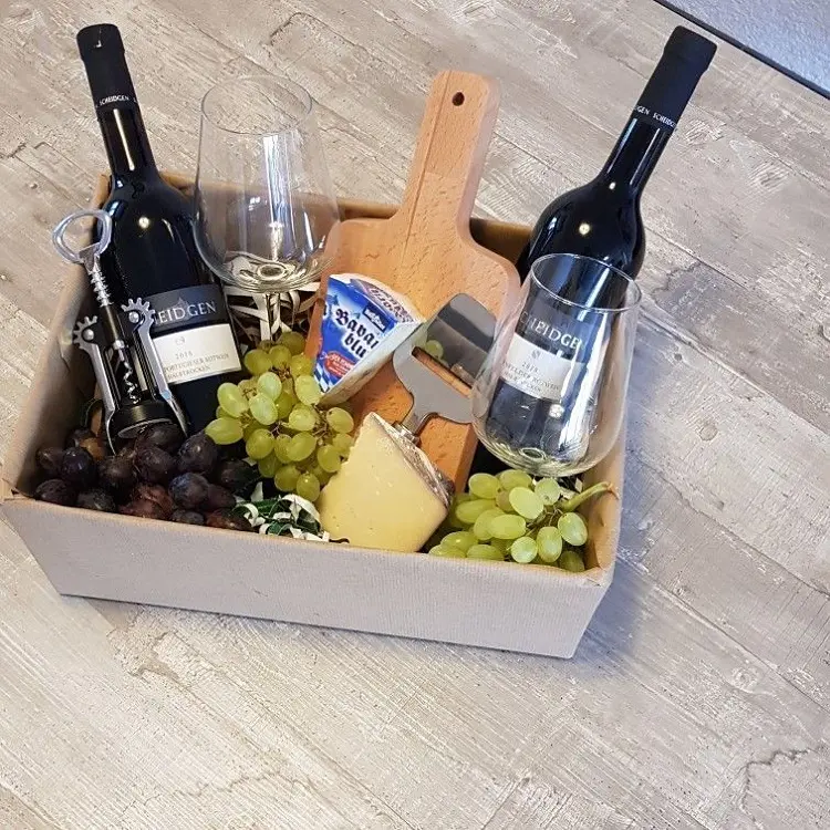 foto de caixa com vinhos, taças, uvas e queijos