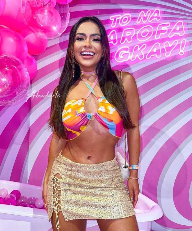 Mulher usando abadá customizado em formato de cropped de amarrar na frente.