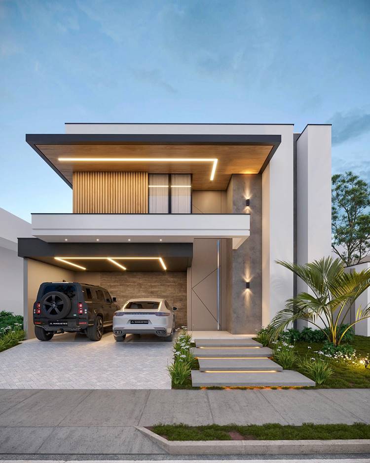Fachada de casa moderna, com dois carros na garagem, iluminação embutida e um jardim pequeno na frente. A casa tem dois andares, com paredes brancas e painéis de madeira no segundo andar. Há degraus que levam à entrada da casa, flanqueados por pequenas áreas de jardim com plantas e grama. O design arquitetônico inclui bordas afiadas e estilo minimalista, com ênfase em linhas horizontais visíveis em elementos como o telhado e os painéis de madeira. A iluminação ambiente adiciona um brilho quente a várias partes do edifício, incluindo sob a saliência do telhado e ao longo dos caminhos