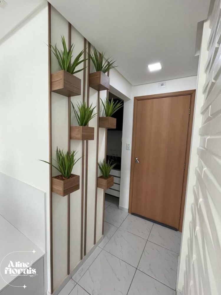 Hall de entrada com parede com vasos marrons de plantas