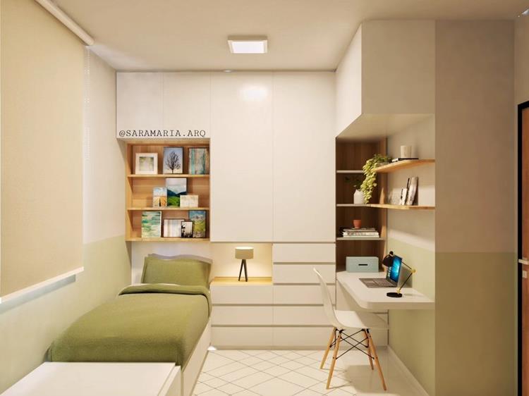 foto de quarto com cama de solteiro com lençol verde, armários brancos e escrivaninha branca