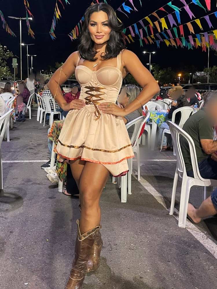 Mulher de pele clara com vestido junino liso bege e bota western 