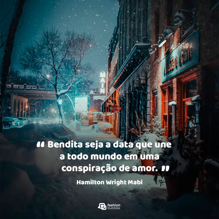Foto de rua iluminada e com neve e frase " “Bendita seja a data que une a todo mundo em uma conspiração de amor.” (Hamilton Wright Mabie)"