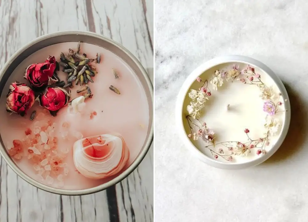 Velas grandes com flores, ervas e pedras no topo