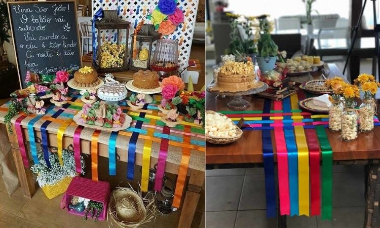 A imagem representa decoração para festa junina. Contém mesa recheada de doces e comidas típicas, com toalha diferente feita com fita de cetim
