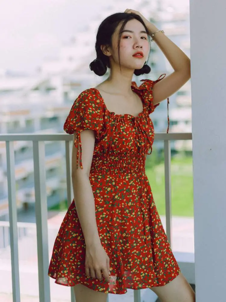 Mulher com vestido estampado como sugestão de roupa vermelha para Natal