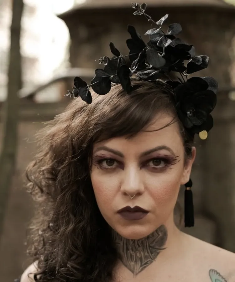 Foto de mulher usando acessório de cabeça com flores pretas