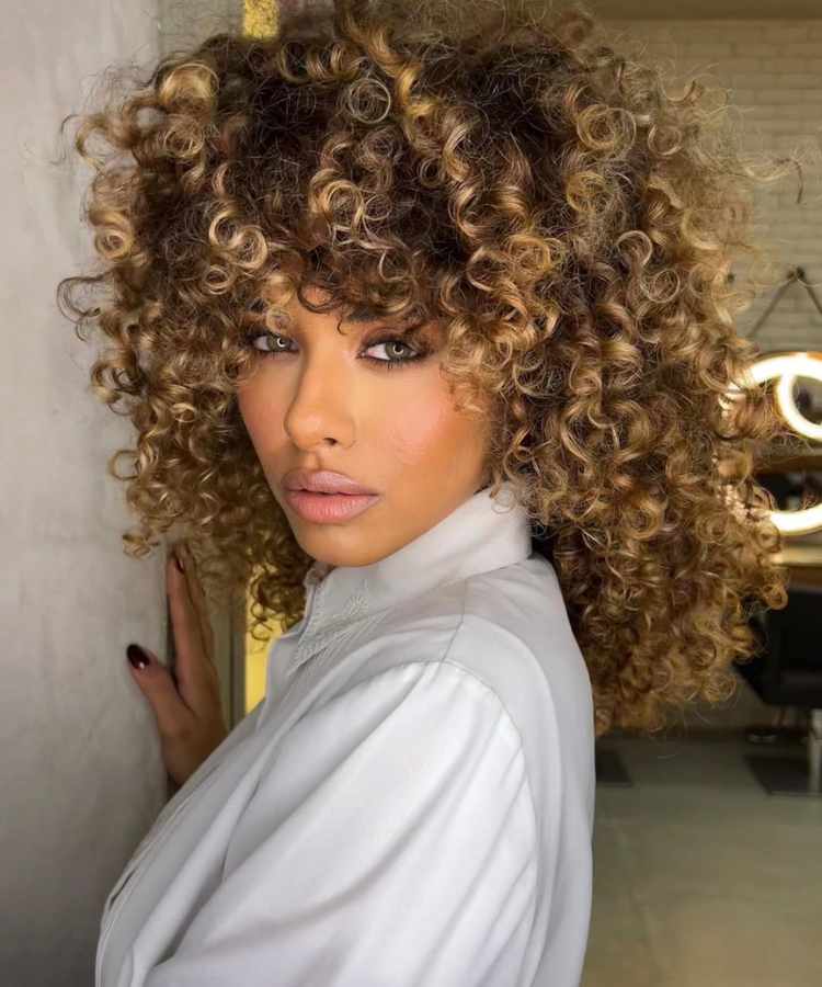 Corte de cabelo com camadas médio crespo.