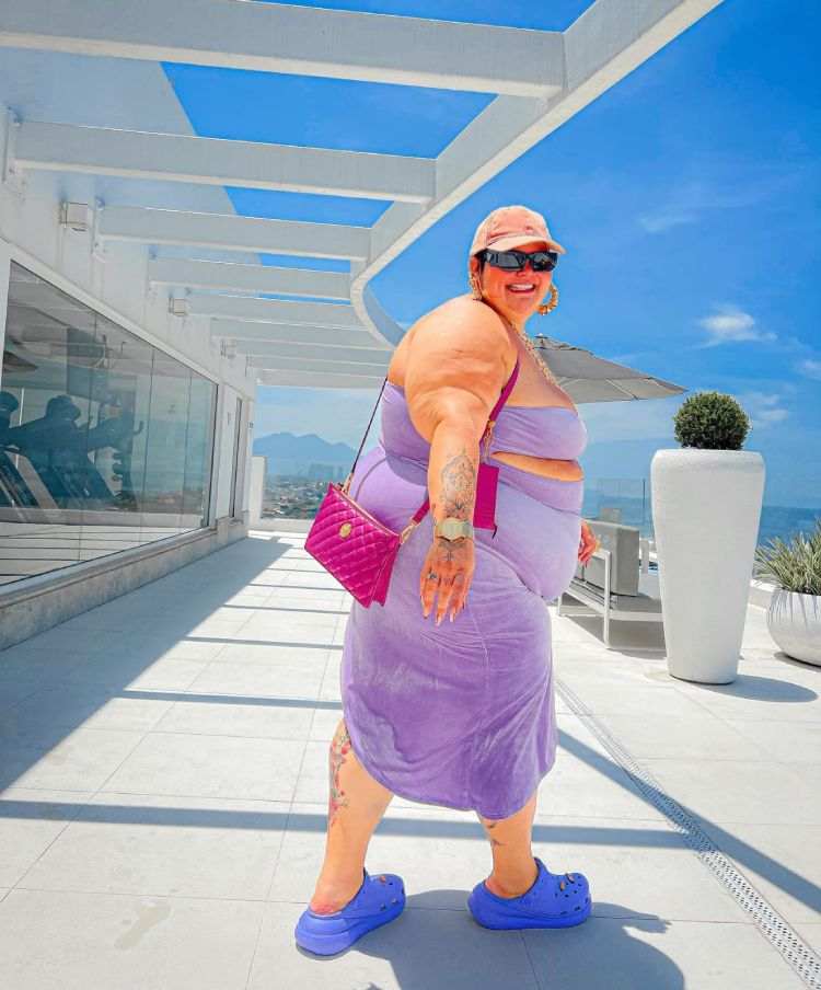 thais carla com vestido longo lilás e bolsa rosa
