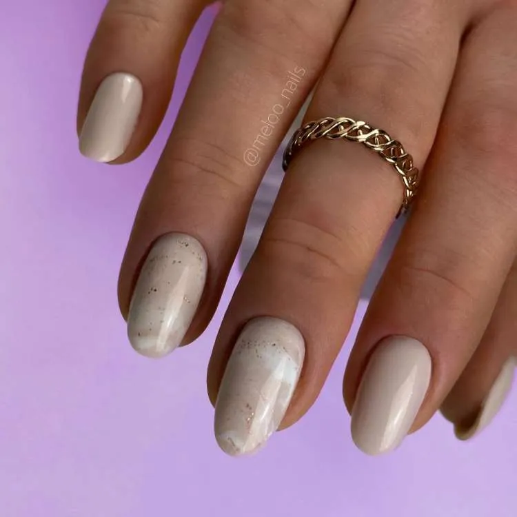 Unhas decoradas nas cores: branco e off-white, com glitter
