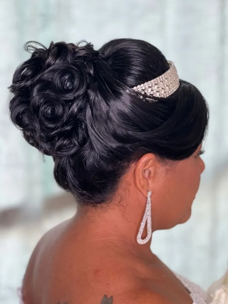 Noiva de pele negra usando coque com cachos e tiara prateada