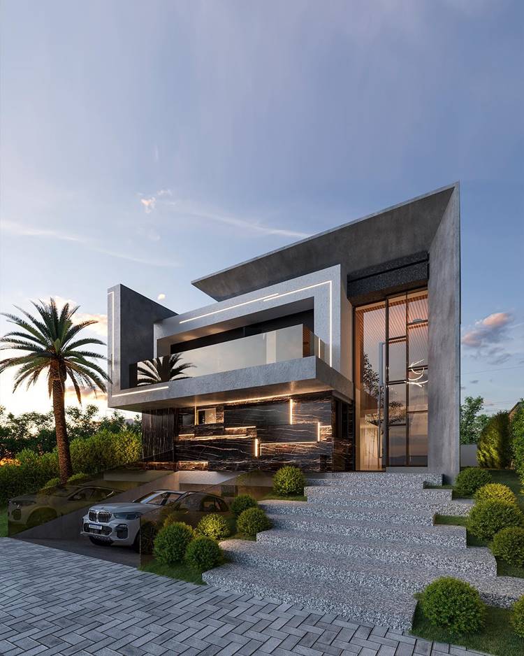 A imagem mostra uma casa moderna, com design geométrico, paredes cinza e janelas grandes. A casa tem vários níveis, com telhados planos e janelas de vidro que permitem a entrada de muita luz natural. Há um jardim bem cuidado ao redor da casa com arbustos e uma palmeira alta. Um carro de luxo está estacionado na entrada que é feita de pedras com padrões. O céu está claro com poucas nuvens indicando início da manhã ou final da tarde, pois a luz do sol ilumina a cena criando sombras suaves.
