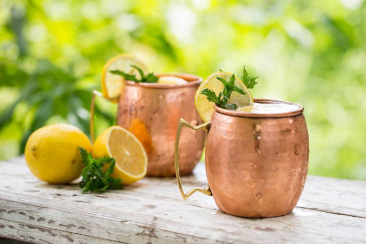 Duas canecas de moscow mule com espuma de gengibre.