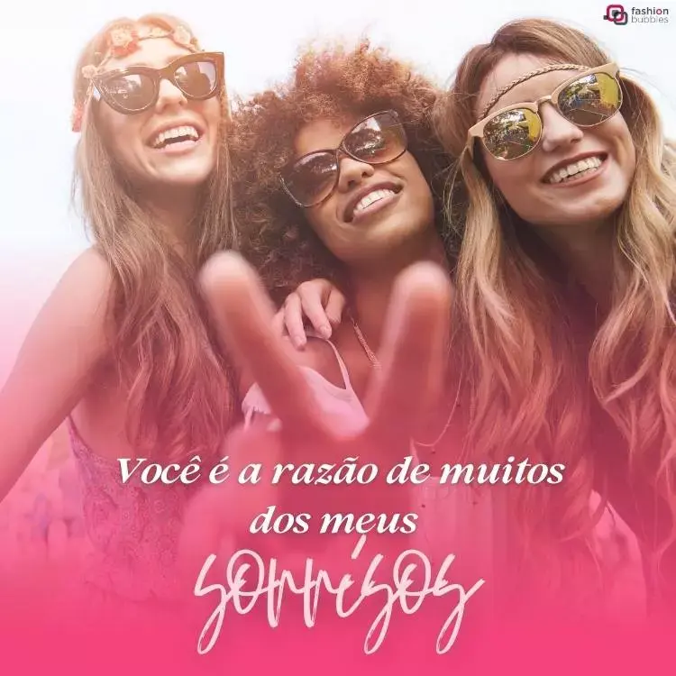 Foto de três mulheres próximas, duas de pele clara e uma de pele negra, todas usando óculos de sol e sorrindo para a foto. Abaixo, um degradê de rosa e a frase "você é a razão de muitos dos meus sorrisos"