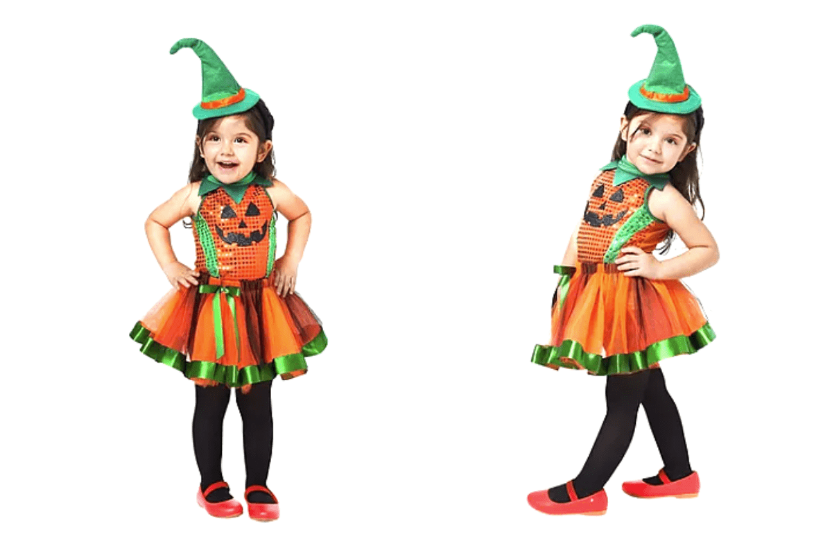 criança fantasiada de abóbora. A fantasia consiste em um chapéu verde, uma blusa de abóbora, uma saia laranja, meia calça preta e sapato vermelho