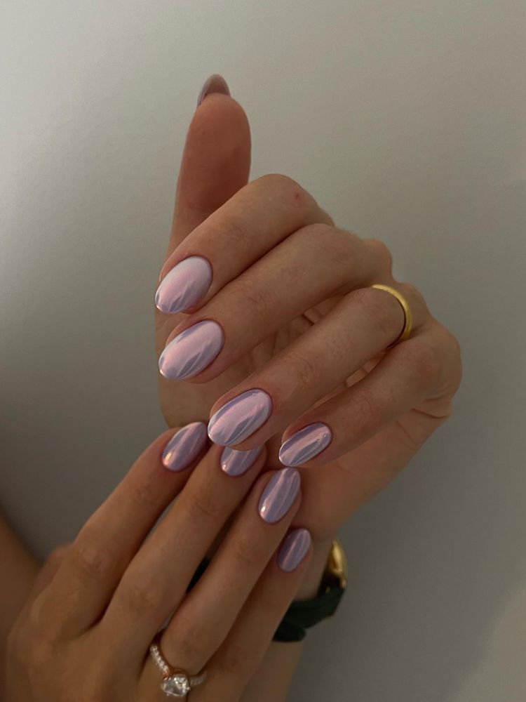 Pessoa de pele clara com unha arredondada curta e esmalte cromado rosa claro