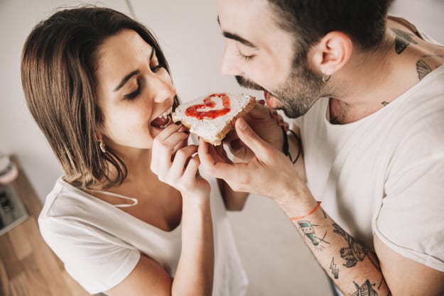 Casal comendo pão juntos