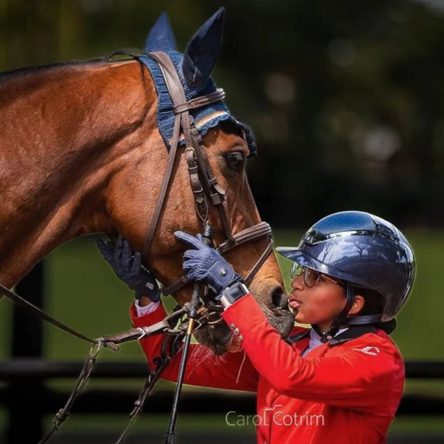 Criança com casaca vermelha da Vainqueur Cheval.