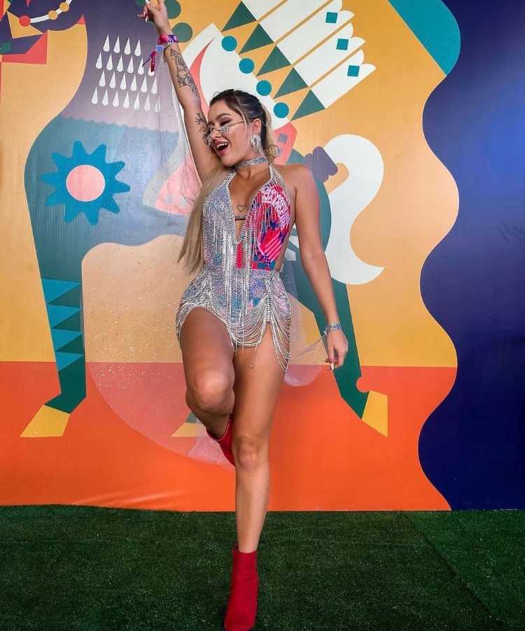 Mulher usando abadá personalizado como body e com franjas de strass.