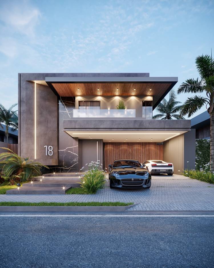 Fachada de casa moderna , com dois andares, paredes cinza escuro e detalhes em madeira. Tem uma garagem para dois carros e iluminação embutida. A casa tem o número “18” na frente e um jardim com várias plantas e árvores. O andar superior tem uma varanda com grades de vidro
