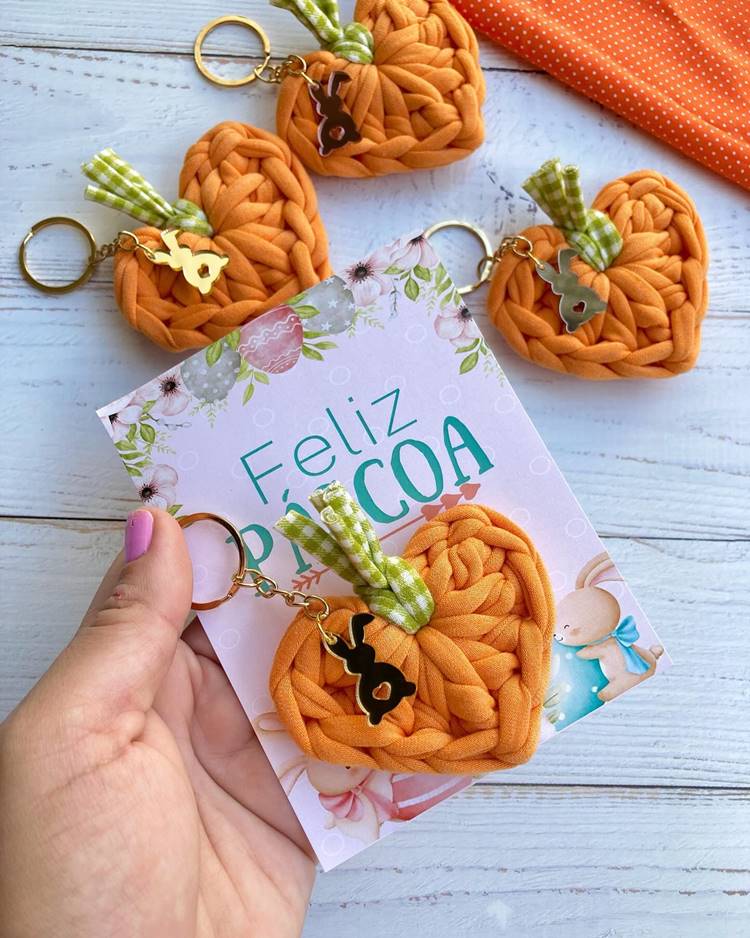 Lembrancinha de Páscoa em crochê: chaveirinho de coração laranja acompanhado de um cartão com a inscrição "Feliz Páscoa" decorativo.

