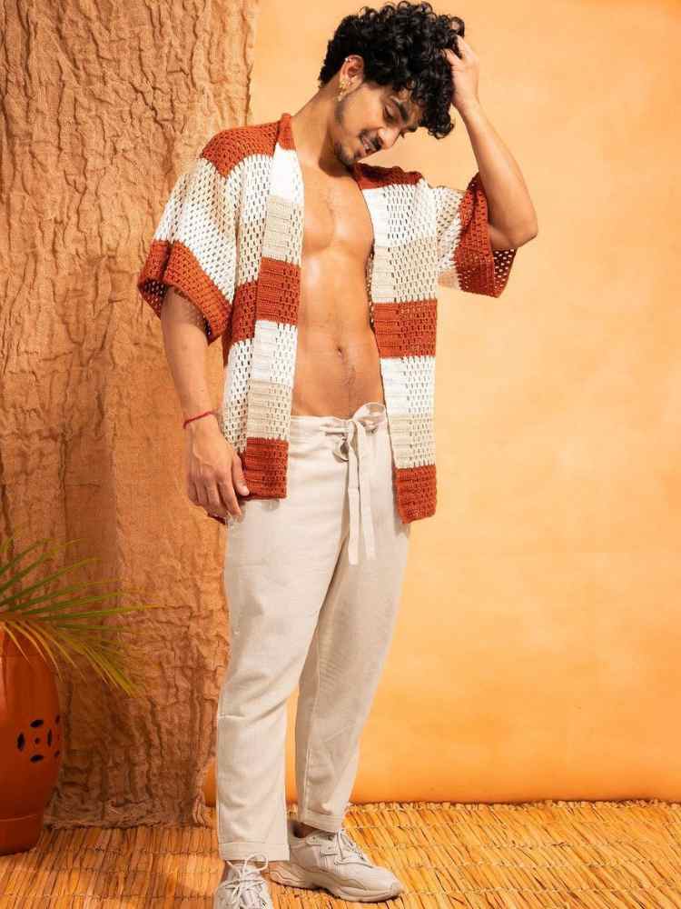 Look para homem virada do ano: quimono de crochê branco, bege e marrom + calça jeans off white.