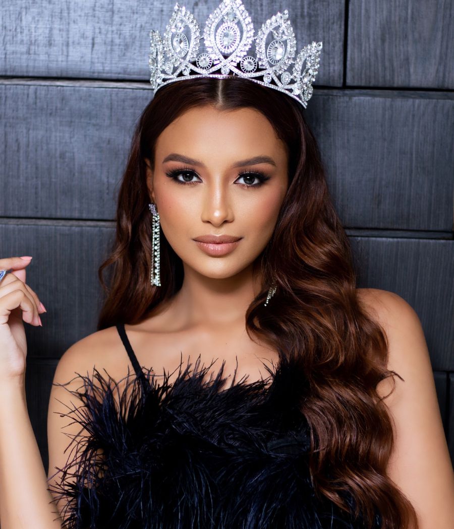 A Miss Pará, candidata do Miss Mundo Brasil, posa com um vestido de plumas preto e a coroa