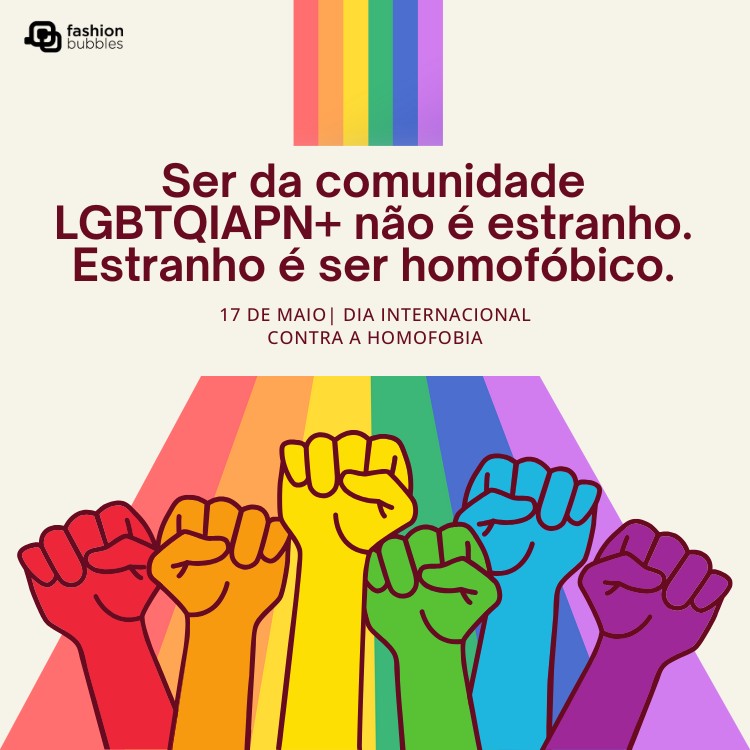 Cartão de fundo bege com cores do arco-íris e mãos com punhos cerrados, além de frase: Ser da comunidade LGBTQIAPN+ não é estranho. Estranho é ser homofóbico.