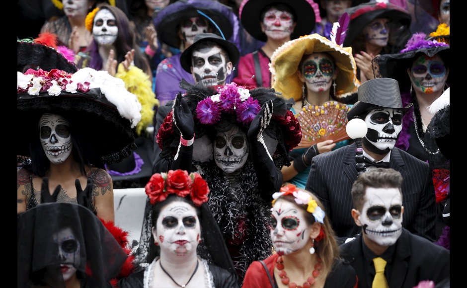 People with their faces painted to look like the popular Mexican figure called "Catrina" take part in the annual Catrina Fest in Mexico City