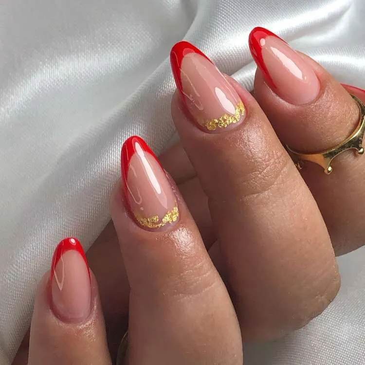 Unhas nude decoradas com francesinha vermelhas e folhas de ouro