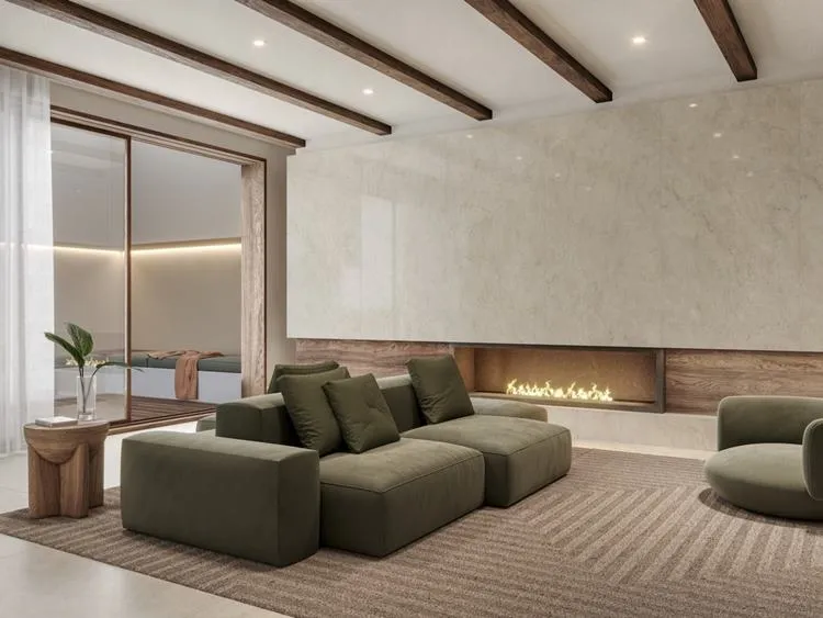 Sala com sofá verde, tapete marrom, lareira com parede em mármore