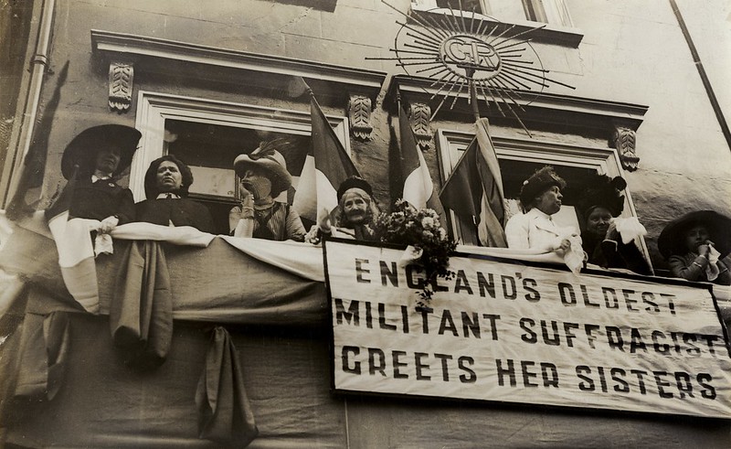 Elizabeth Wolstenholme observa uma processão de mulheres sufragistas em 1911.
