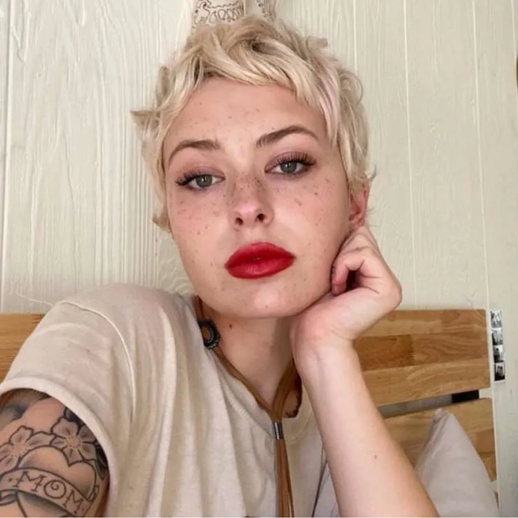 Mulher com cabelo platinado muito curto e repicado